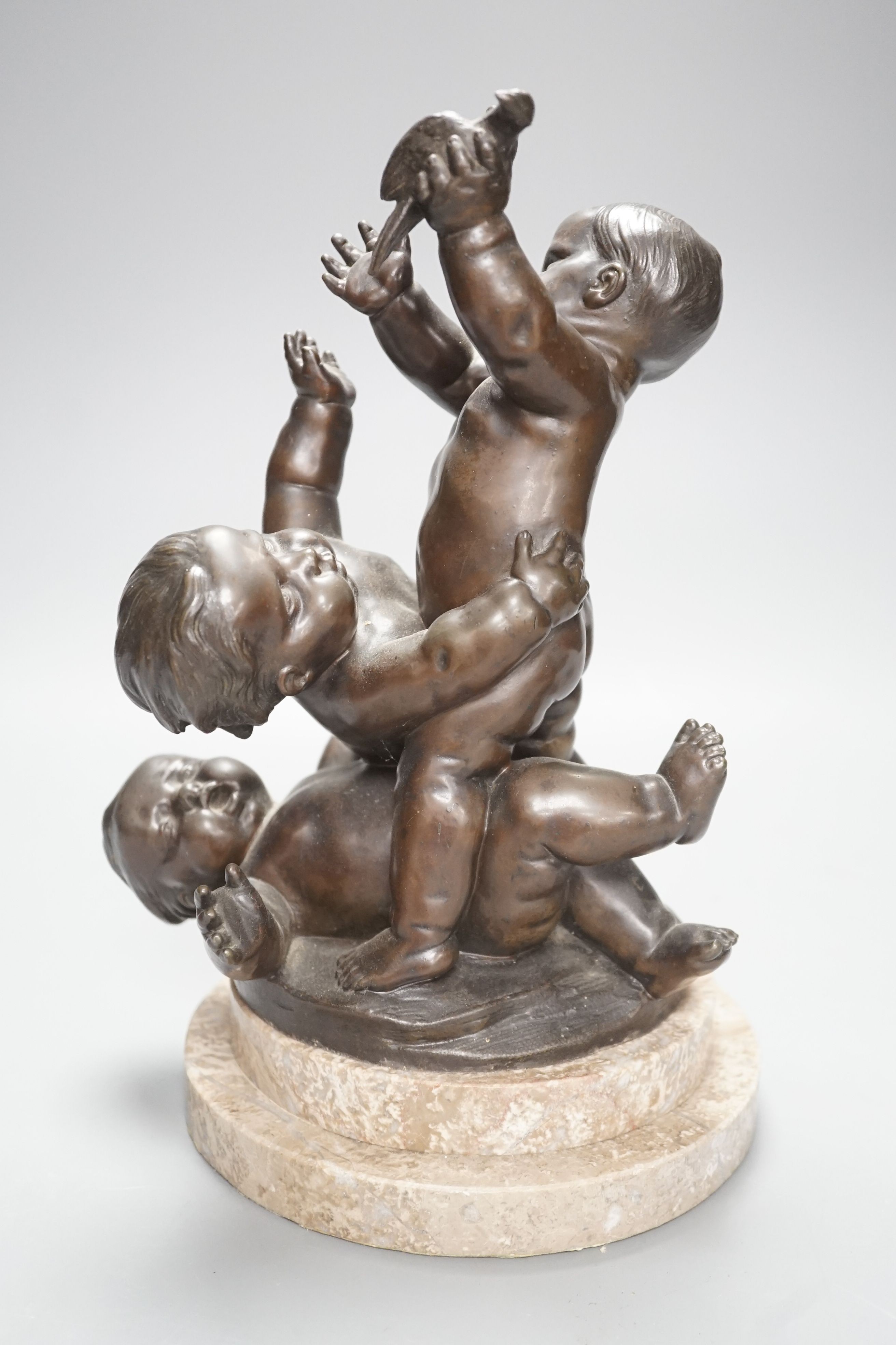 A bronze figure group of a trio of putto, height 28cm